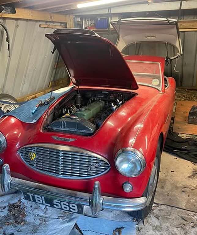 Austin-Healey 3000 with its bonnet open, being repaired after a year laid up